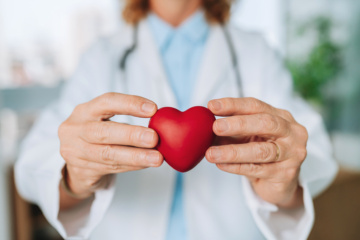 female doctor holding red heart
