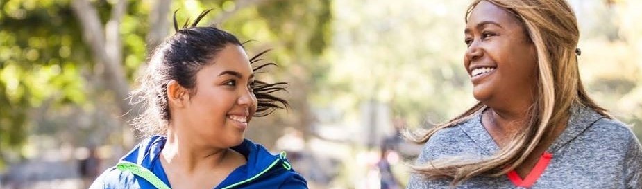 Two women walking together and smiling
